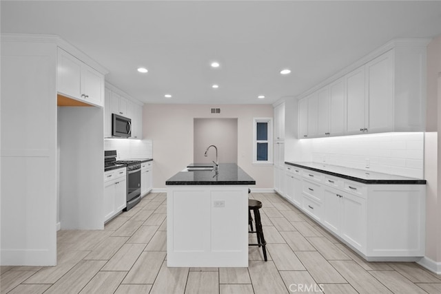 17148 Stare St, Northridge, CA 91325 - kitchen with appliances with stainless steel finishes, a sink, decorative backsplash, recessed lighting, and white cabinets