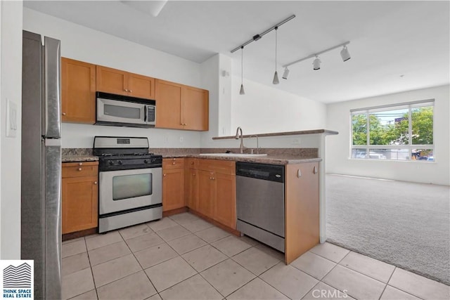 100 S Alameda St Unit 162, Los Angeles, CA 90012 - kitchen featuring appliances with stainless steel finishes, a sink, light carpet, open floor plan, and a peninsula