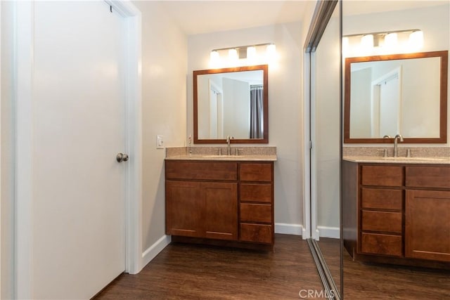28956 Canyon Lake Dr Unit 43, Lake Forest, CA 92679 - bathroom featuring two vanities and wood finished floors