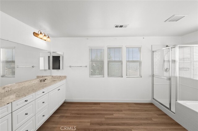 30183 Redding Ave, Murrieta, CA 92563 - full bathroom featuring wood finished floors, vanity, a shower stall, a tub, and baseboards