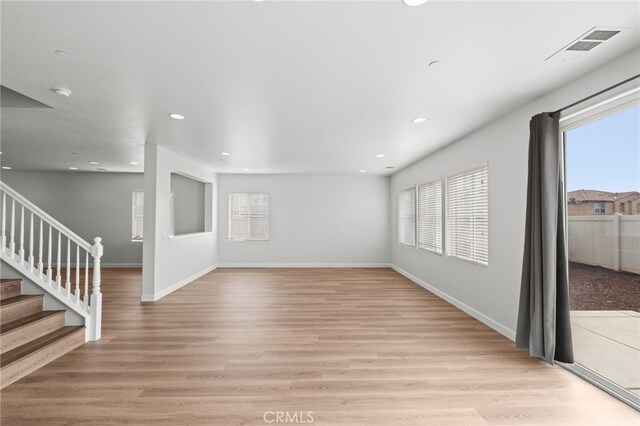 30183 Redding Ave, Murrieta, CA 92563 - unfurnished living room with plenty of natural light, stairway, light wood finished floors, and recessed lighting