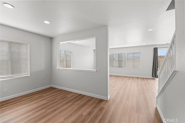 30183 Redding Ave, Murrieta, CA 92563 - empty room featuring light wood finished floors, baseboards, recessed lighting, and stairs