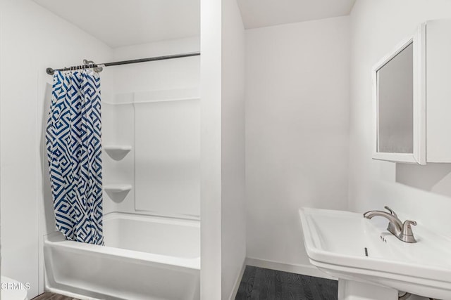 124 N Driskill St, Oxnard, CA 93030 - bathroom with a sink, wood finished floors, shower / bath combination with curtain, and baseboards
