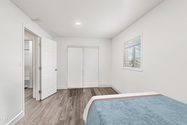 124 N Driskill St, Oxnard, CA 93030 - unfurnished bedroom with wood finished floors, baseboards, and a closet
