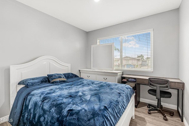 124 N Driskill St, Oxnard, CA 93030 - bedroom with light wood-type flooring and baseboards