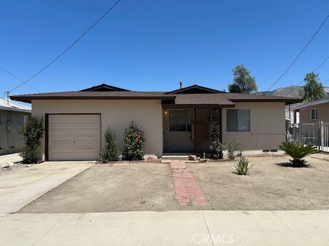339 W Main St, San Jacinto, CA 92583 - ranch-style house with stucco siding, an attached garage, and concrete driveway