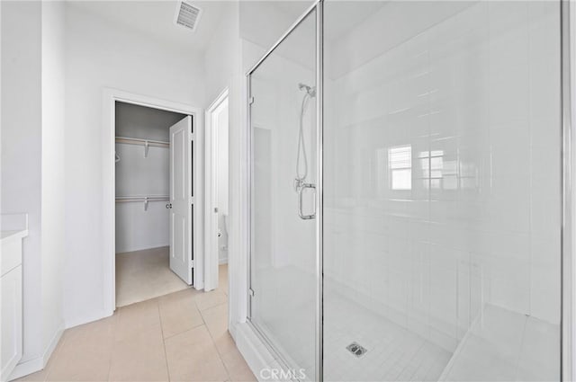 143 Frame, Irvine, CA 92618 - full bath featuring a shower stall, tile patterned floors, a walk in closet, toilet, and baseboards