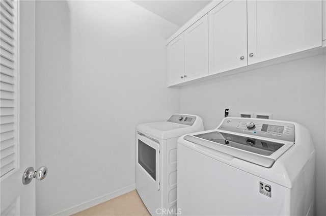 143 Frame, Irvine, CA 92618 - laundry area featuring washing machine and dryer, cabinet space, baseboards, and light tile patterned flooring