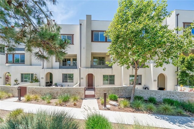 143 Frame, Irvine, CA 92618 - view of front of home featuring a fenced front yard, stucco siding, and a gate