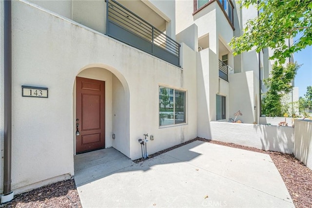 143 Frame, Irvine, CA 92618 - view of exterior entry featuring stucco siding and a patio area