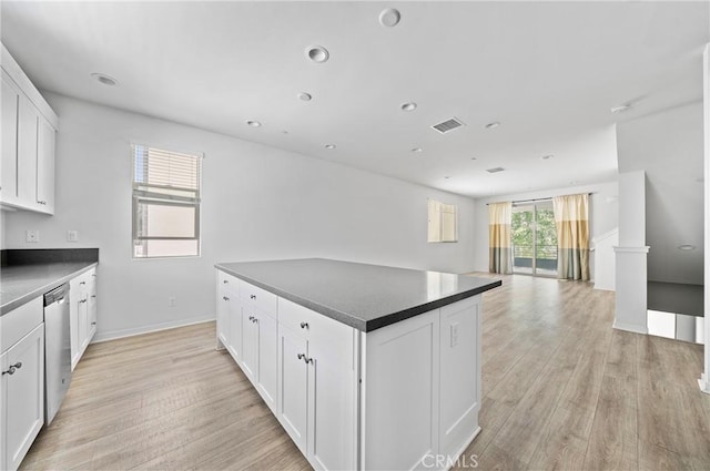 143 Frame, Irvine, CA 92618 - kitchen featuring dishwasher, light wood finished floors, dark countertops, white cabinets, and recessed lighting