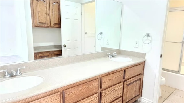 7240 Meadowlark Pl, Rancho Cucamonga, CA 91701 - bathroom with tile patterned floors, double vanity, combined bath / shower with glass door, and toilet