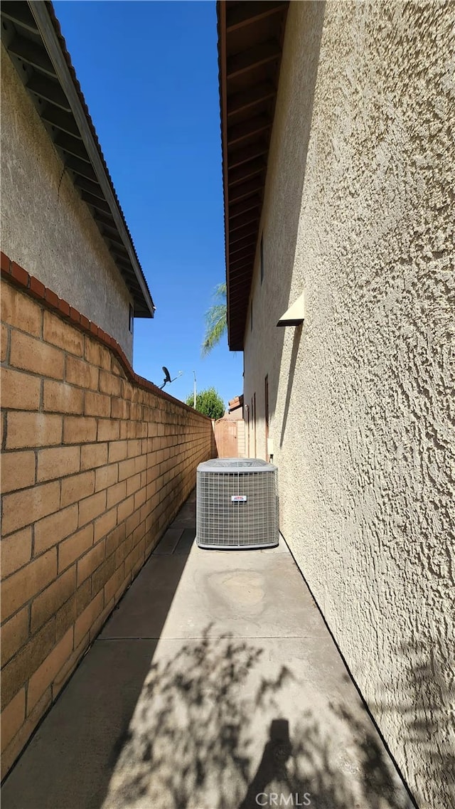 7240 Meadowlark Pl, Rancho Cucamonga, CA 91701 - view of side of property with stucco siding, central air condition unit, and a patio area