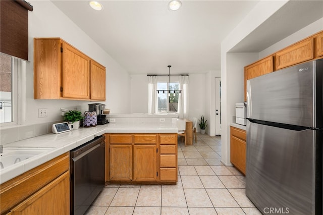 2226 Flash Ct, Perris, CA 92571 - kitchen with freestanding refrigerator, dishwashing machine, a peninsula, light tile patterned flooring, and tile counters