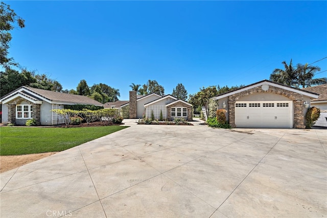 5571 Mountain View Ave, Yorba Linda, CA 92886 - view of front of home featuring stone siding, driveway, a garage, and a front yard