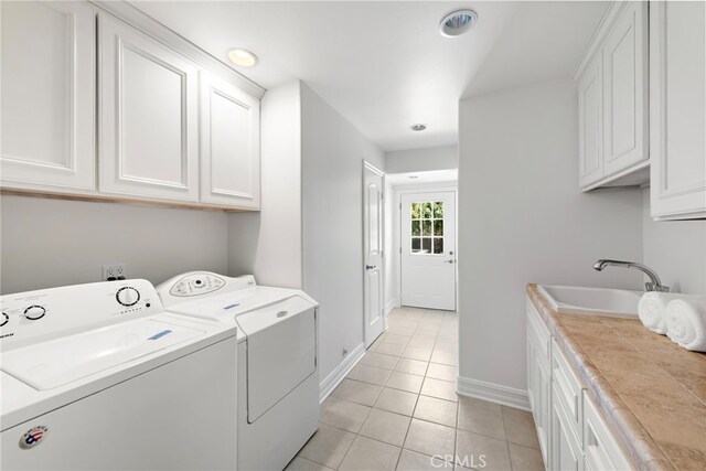 5571 Mountain View Ave, Yorba Linda, CA 92886 - washroom featuring cabinet space, washing machine and dryer, light tile patterned floors, and baseboards