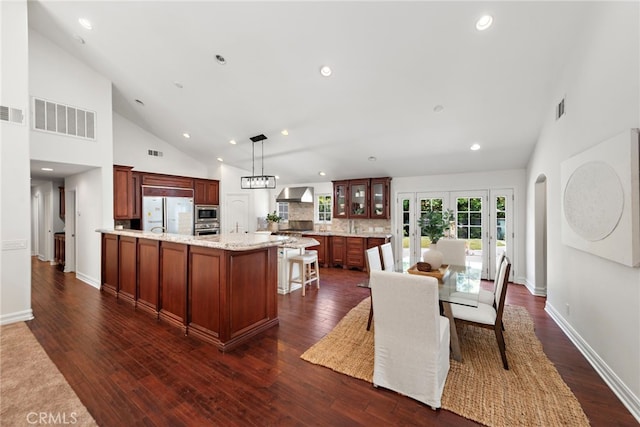 5571 Mountain View Ave, Yorba Linda, CA 92886 - kitchen with stainless steel appliances, glass insert cabinets, high vaulted ceiling, a kitchen bar, and recessed lighting