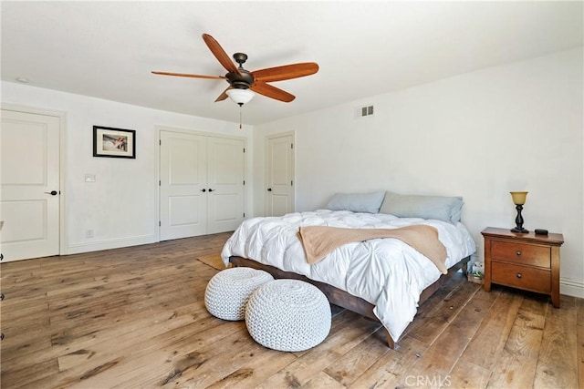 9900 Carmelita Ave, Atascadero, CA 93422 - bedroom featuring hardwood / wood-style floors, a closet, baseboards, and ceiling fan