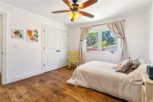 9900 Carmelita Ave, Atascadero, CA 93422 - bedroom featuring hardwood / wood-style floors, a ceiling fan, baseboards, and a closet