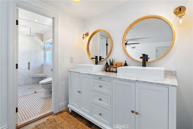 9900 Carmelita Ave, Atascadero, CA 93422 - full bath with a shower stall, toilet, double vanity, and wood finished floors