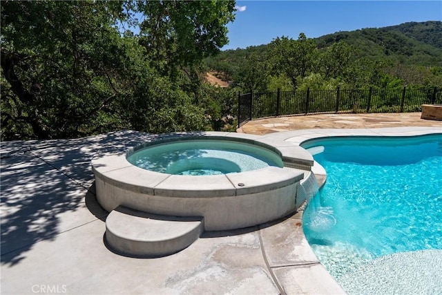 9900 Carmelita Ave, Atascadero, CA 93422 - view of pool featuring a pool with connected hot tub, a forest view, and a patio