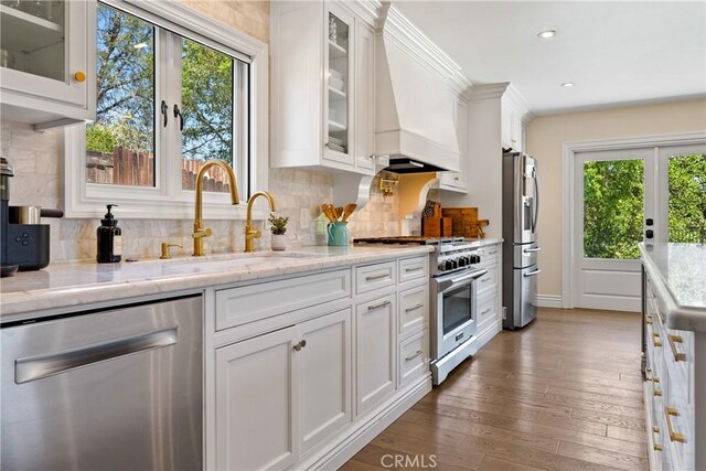 9900 Carmelita Ave, Atascadero, CA 93422 - kitchen featuring appliances with stainless steel finishes, healthy amount of natural light, white cabinetry, wood finished floors, and recessed lighting
