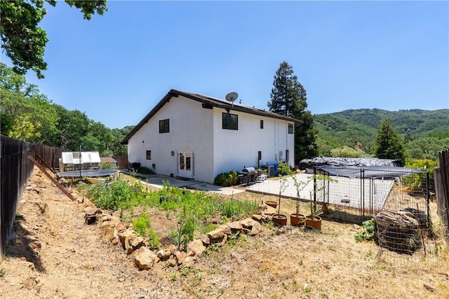9900 Carmelita Ave, Atascadero, CA 93422 - rear view of property featuring stucco siding, a fenced backyard, a patio area, and a mountain view