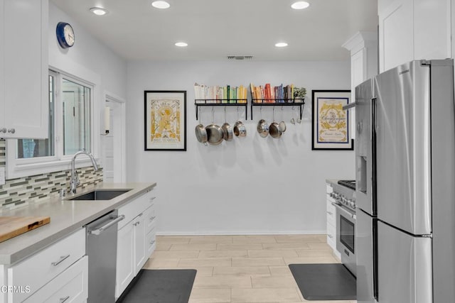 863 N Hill Ave, Pasadena, CA 91104 - kitchen with stainless steel appliances, white cabinets, tasteful backsplash, a sink, and recessed lighting