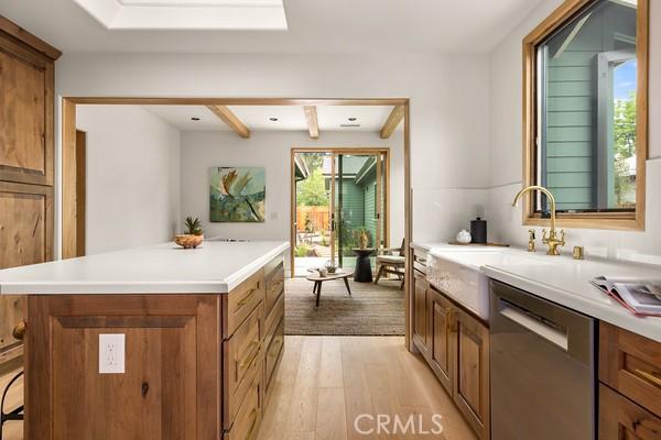 4958 Highland View Ave, Los Angeles, CA 90041 - kitchen with dishwasher, a sink, brown cabinets, and light wood-type flooring
