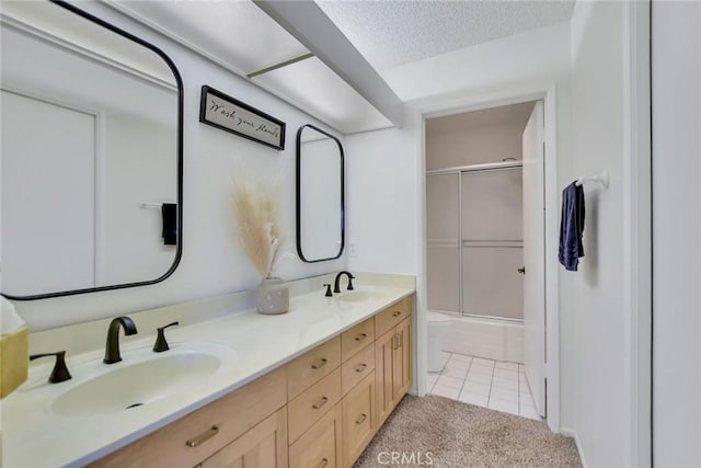 8866 Tulare Dr Unit 301C, Huntington Beach, CA 92646 - full bathroom featuring double vanity, tile patterned floors, enclosed tub / shower combo, and a textured ceiling