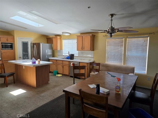 36255 Grapevine Canyon Rd, Ranchita, CA 92066 - kitchen featuring appliances with stainless steel finishes, a skylight, a center island, ceiling fan, and light countertops