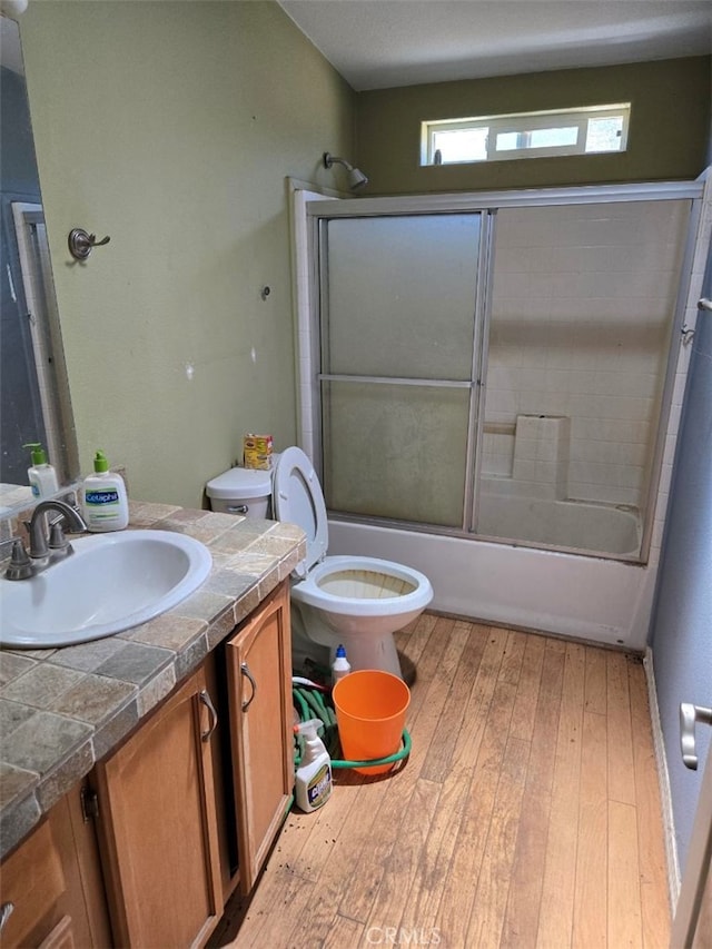 36255 Grapevine Canyon Rd, Ranchita, CA 92066 - bathroom featuring vanity, toilet, wood-type flooring, and combined bath / shower with glass door