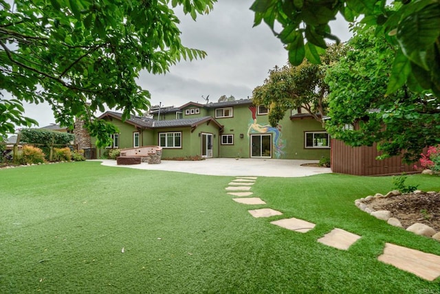 398 Aliso St, Ventura, CA 93001 - back of property with stucco siding, a patio area, and a lawn