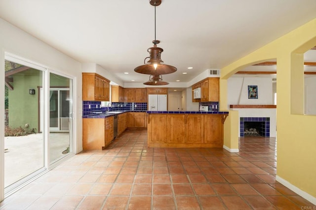 398 Aliso St, Ventura, CA 93001 - kitchen featuring a peninsula, backsplash, white appliances, a sink, and light tile patterned flooring