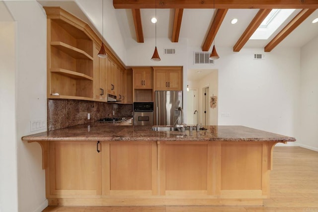 398 Aliso St, Ventura, CA 93001 - kitchen with appliances with stainless steel finishes, a peninsula, dark stone counters, beam ceiling, and a sink
