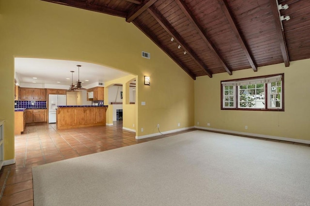 398 Aliso St, Ventura, CA 93001 - unfurnished living room with wood ceiling with exposed beams, arched walkways, baseboards, high vaulted ceiling, and light tile patterned flooring