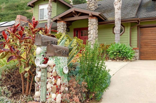 398 Aliso St, Ventura, CA 93001 - doorway to property featuring a chimney, a shingled roof, driveway, and an attached garage