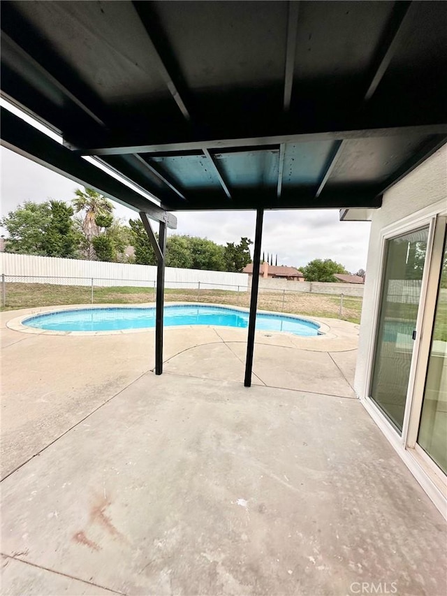 view of swimming pool with a fenced backyard and a patio area