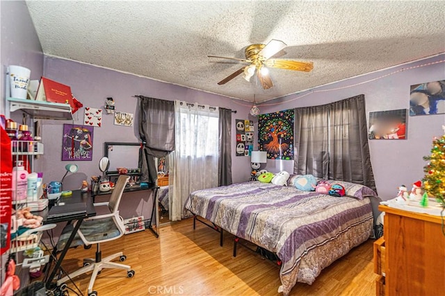 5011 Hedrick Ave, Riverside, CA 92505 - bedroom with a textured ceiling, wood finished floors, a desk, and a ceiling fan