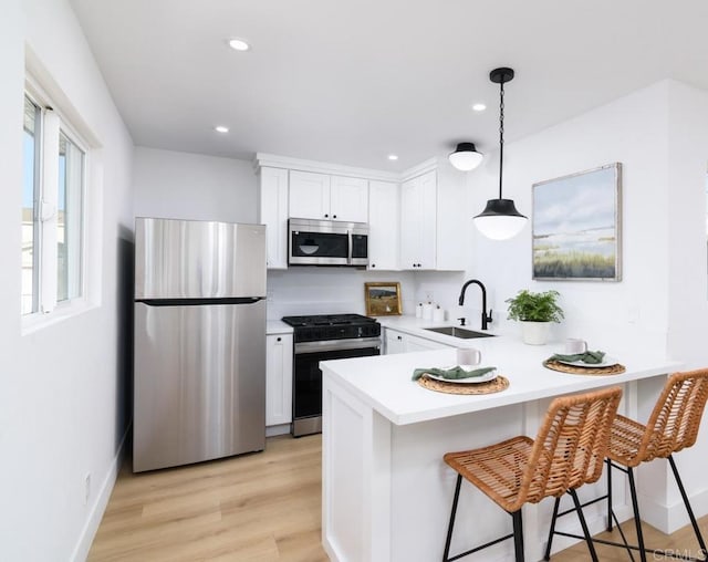 444547 N 42nd St, San Diego, CA 92116 - kitchen featuring appliances with stainless steel finishes, a sink, a peninsula, light countertops, and white cabinets
