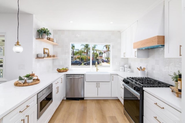 444547 N 42nd St, San Diego, CA 92116 - kitchen featuring stainless steel appliances, custom exhaust hood, white cabinetry, open shelves, and decorative backsplash