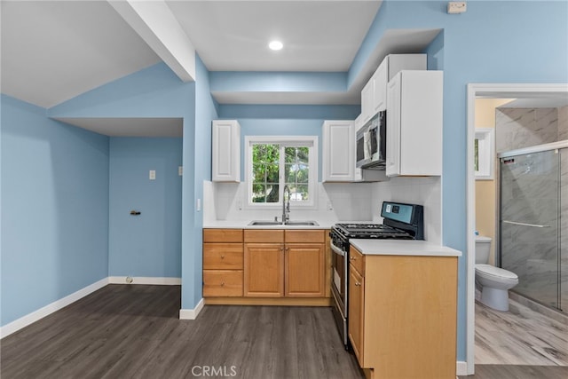 15711 Hiawatha St, Granada Hills, CA 91344 - kitchen featuring a sink, appliances with stainless steel finishes, dark wood-style floors, light countertops, and white cabinetry