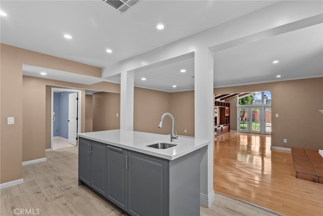 15711 Hiawatha St, Granada Hills, CA 91344 - kitchen with a sink, gray cabinetry, light wood-style floors, light countertops, and recessed lighting