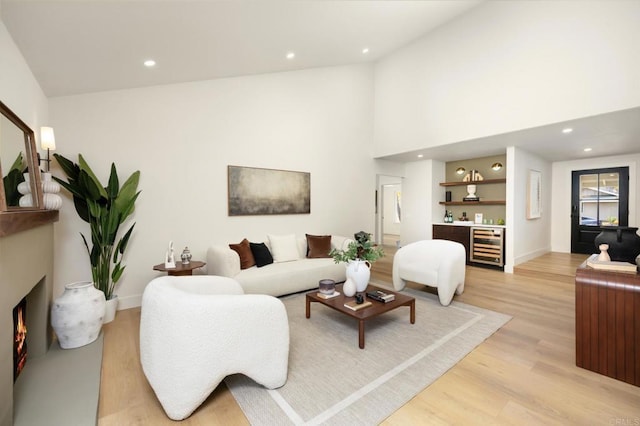 23162 La Vaca St, Lake Forest, CA 92630 - living area featuring light wood finished floors, a dry bar, recessed lighting, a warm lit fireplace, and beverage cooler