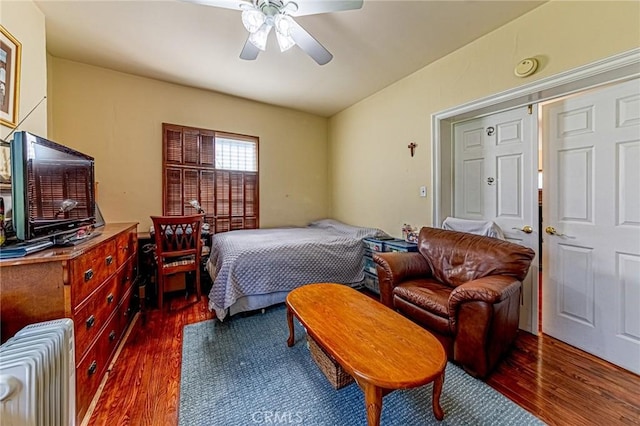 1151 Arapahoe St, Los Angeles, CA 90006 - bedroom with radiator, dark wood-style floors, and a ceiling fan