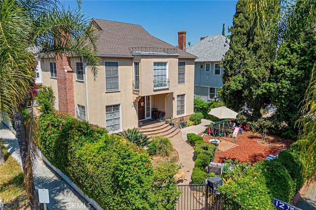 1151 Arapahoe St, Los Angeles, CA 90006 - rear view of house with stucco siding and roof with shingles