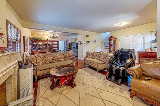 1151 Arapahoe St, Los Angeles, CA 90006 - living area featuring stairway, a chandelier, a high end fireplace, and wood finished floors