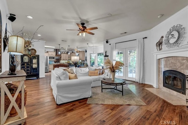 17276 Iona Ave, Lemoore, CA 93245 - living area featuring a ceiling fan, wood finished floors, a tiled fireplace, recessed lighting, and baseboards