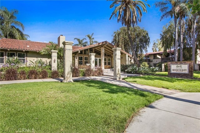 1345 Cabrillo Park Dr Unit J08, Santa Ana, CA 92701 - view of front of property featuring a chimney, stucco siding, and a front lawn