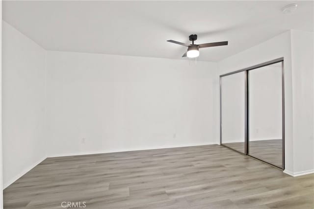 1345 Cabrillo Park Dr Unit J08, Santa Ana, CA 92701 - unfurnished bedroom featuring light wood-style flooring, a closet, baseboards, and a ceiling fan